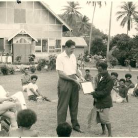 Savings and Loan Society - John Phillips, Registrar of the Society, presenting Certificates of Registration to James Deko, president of the first Savings and Loan Society, Sideia, Territory of Papua New Guinea - 1962
