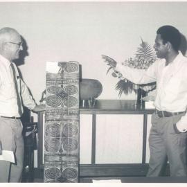 Miscellaneous - Premises - Other Banks - Bank of Papua New Guinea - BPNG takes over from RBA - Sir John Phillips (Governor RBA) accepting the fighting shield presented by Governor ToRobert to the Reserve Bank - 1 November 1973