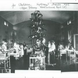Staff - Head Office - Commonwealth Bank of Australia - Charity - Christmas tree donated by the Cot Fund Committee to the Upper Todman Surgical Ward - Miss Myall McCourt in Santa outfit - 23 December 1919