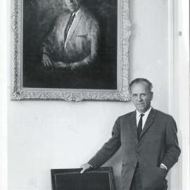 Staff - Individual Officers - The opening of the HC Coombs Building, at the Australian National University - Dr HC Coombs posing beside a portrait of himself by Clifton Pugh - 11 September 1964