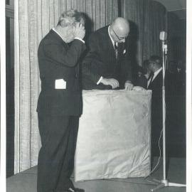 HC Coombs' farewell as Governor - DA Tate unwraps staffs' gift, prior to presentation to Governor - July 1968