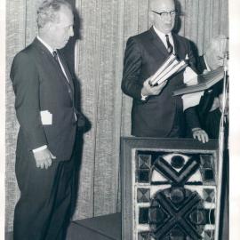 Staff - Social functions - Head Office 65 Martin Place - Dr HC Coombs' retirement function - Mr DA Tate presenting Dr Coombs with a farewell gift of a painting commissioned by Leonard French - 22 July 1968