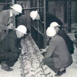 Adelaide Project - 1963-June 1967 - Mr Dallwitz showing a section of tangbar reinforced floor to Messrs Schumacher, Jensen, Alexander and Chittenden - 22 October 1964