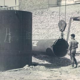 Adelaide Project - 1963-June 1967 - 6' steel liner positioned in the shaft, while alongside 5' liner is being lifted - 6 December 1963