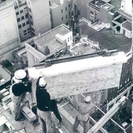 Melbourne Project - December 1961-September 1966 - A granite spandrel being hoisted into position at 16th floor level (western face) - 19 November 1965