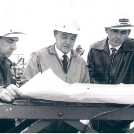 Melbourne Project - December 1961-September 1966 - Departmental supervisors discussing roof construction detail with representative of the builder - 13 July 1965