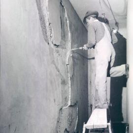 Melbourne Project - December 1961-September 1966 - Removing "drummy" render from wall in corridor around strongroom No. 1 - 20 May 1965