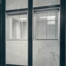 New Head Office Building - June 1960-January 1963 - External view showing Sienna marble (left), light Wombeyan Blue (right).  Polished Adelong black column faces and Mudgee Russet polished granite horizontal strip to the base of the spandrels - c.1963