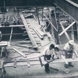 New Head Office Building - June 1960-January 1963 -  Excavations for No. 9 lift pit (left) and ejector pit - carpenters preparing form work for concreting around columns - 1 February 1962