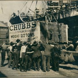 Government Savings Bank of New South Wales - Chubb strong room doors on dock surrounded by wharf workers - for new Head Office in Martin Place - 11 October 1926